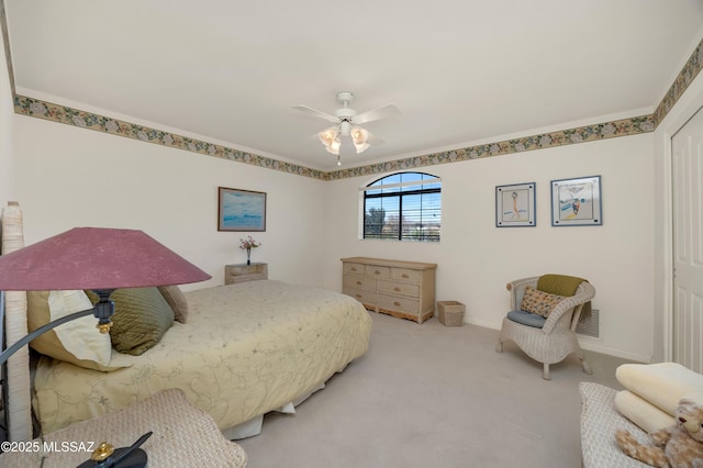 bedroom featuring light carpet and ceiling fan