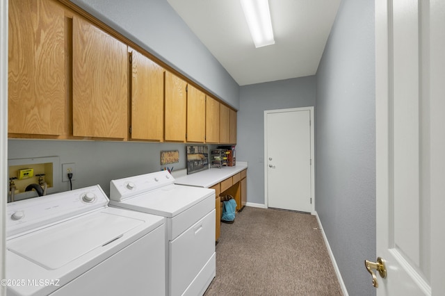 clothes washing area with light carpet, cabinets, and washer and dryer