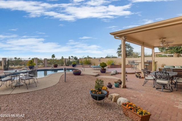 view of patio with a fenced in pool and ceiling fan