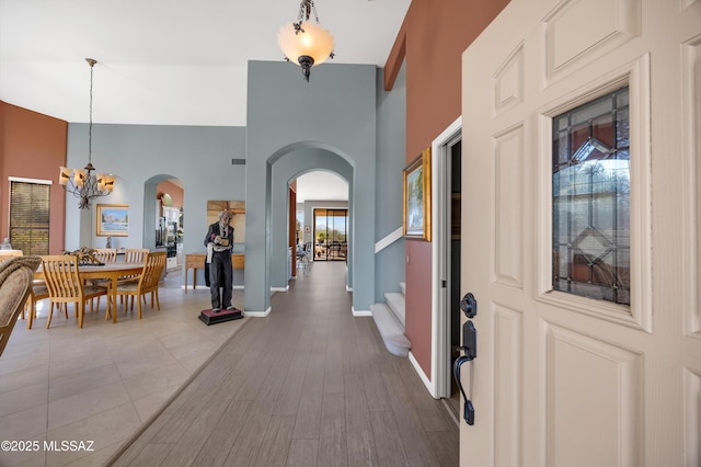 entrance foyer with hardwood / wood-style floors and a chandelier