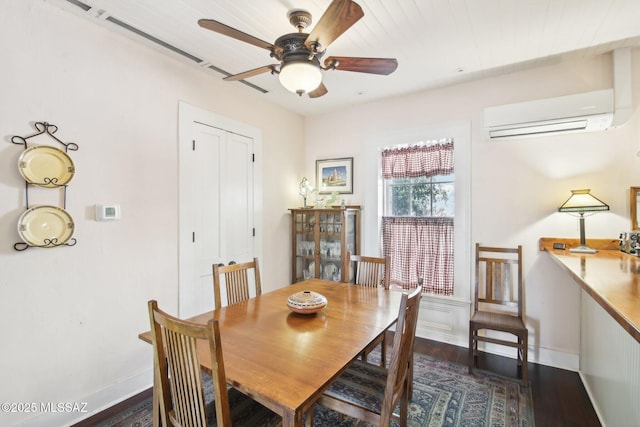 dining area with ceiling fan, dark hardwood / wood-style floors, and a wall mounted AC