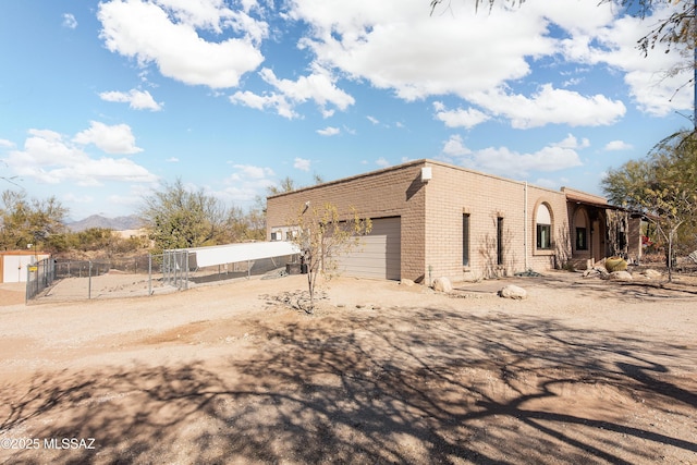 view of home's exterior featuring a garage and a mountain view