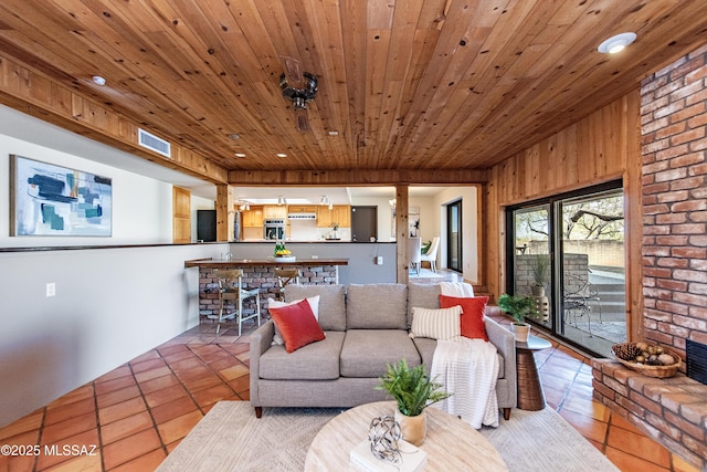 tiled living room with wooden ceiling and wood walls