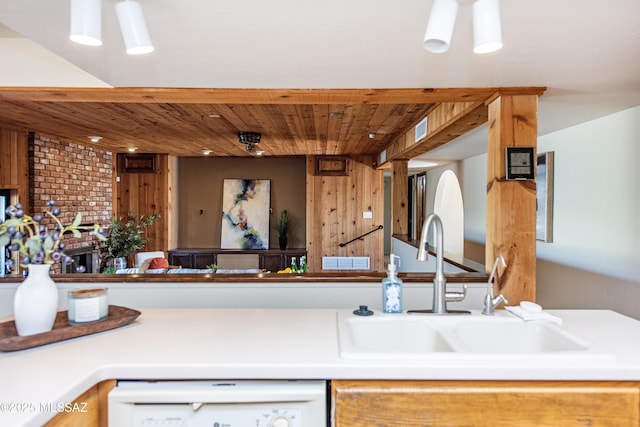 kitchen featuring dishwashing machine, wood ceiling, and sink