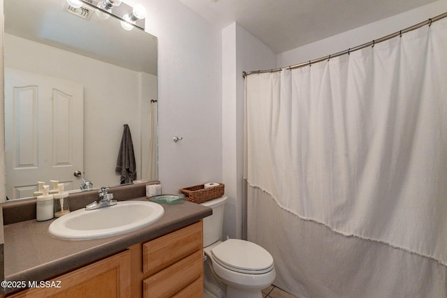 bathroom featuring toilet and vanity