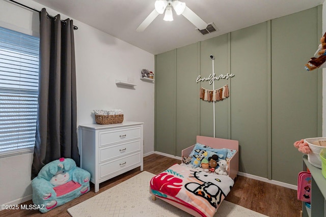 bedroom with ceiling fan and dark hardwood / wood-style floors