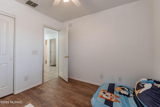 unfurnished bedroom featuring a closet, ceiling fan, and hardwood / wood-style flooring