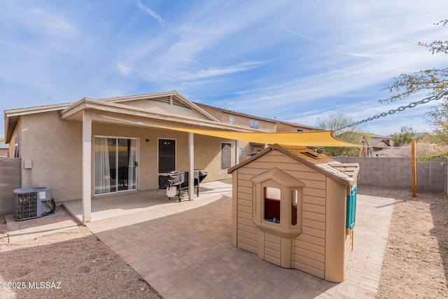 view of patio featuring cooling unit and a storage unit