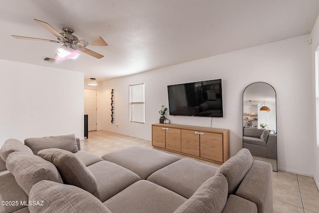 tiled living room with ceiling fan