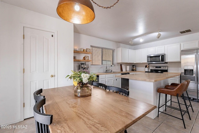 tiled dining space featuring sink