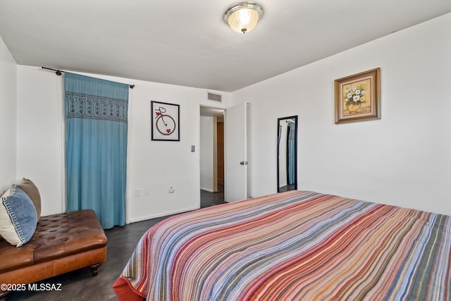 bedroom featuring finished concrete floors and visible vents