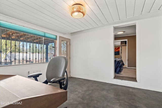 office featuring wooden ceiling, concrete floors, and baseboards