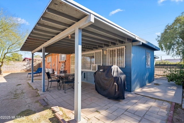 view of patio / terrace featuring a grill and fence