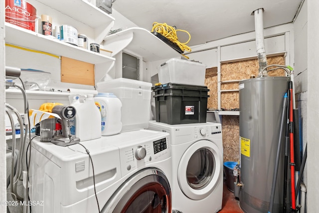 washroom featuring laundry area, water heater, and separate washer and dryer