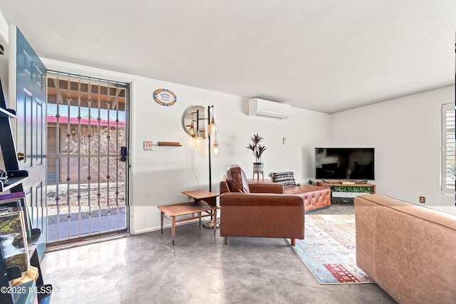 living room with concrete floors and a wall mounted air conditioner