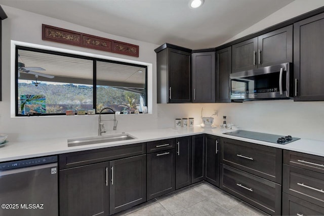 kitchen featuring sink, light tile patterned floors, ceiling fan, and appliances with stainless steel finishes