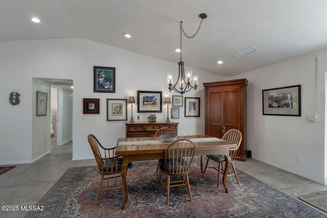 dining room with a notable chandelier and vaulted ceiling