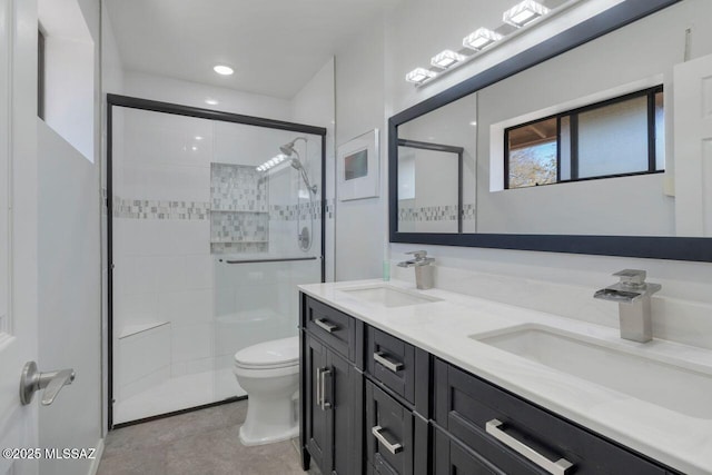 bathroom with vanity, toilet, walk in shower, and tile patterned floors