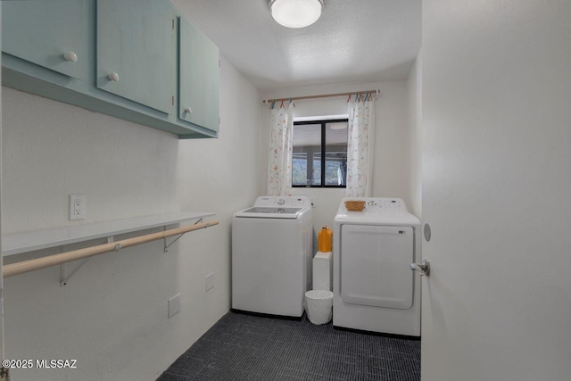 washroom with cabinets and washing machine and dryer