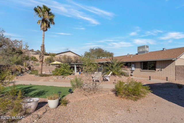 view of yard with central AC unit and a patio