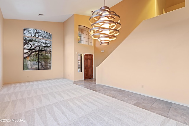 interior space with a chandelier and light carpet