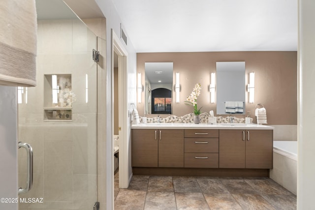 bathroom with vanity and separate shower and tub