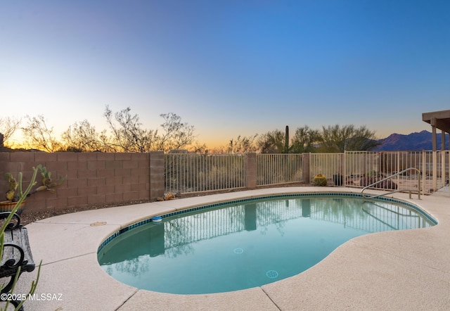 view of pool at dusk