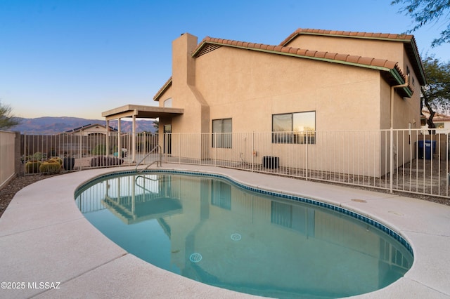 view of swimming pool with a patio area and a mountain view