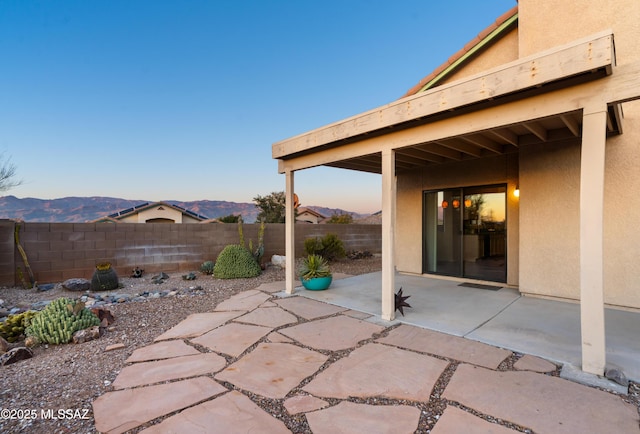 patio terrace at dusk with a mountain view