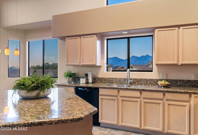 kitchen with a mountain view, sink, light brown cabinets, and dishwasher