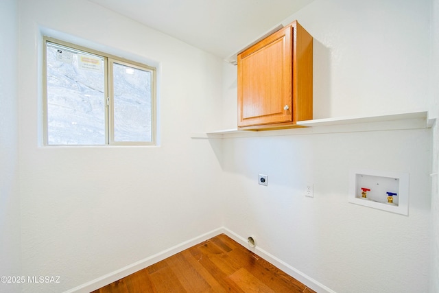 laundry room with hookup for a washing machine, electric dryer hookup, cabinets, and hardwood / wood-style flooring