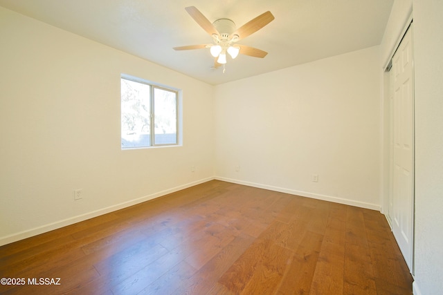 unfurnished bedroom with a closet, ceiling fan, and dark hardwood / wood-style flooring