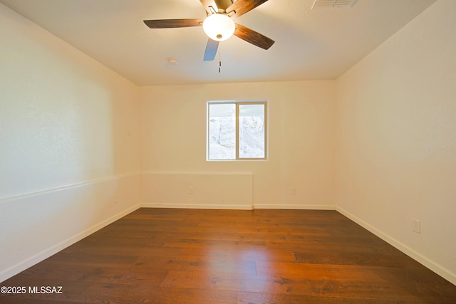 empty room with dark wood-type flooring and ceiling fan