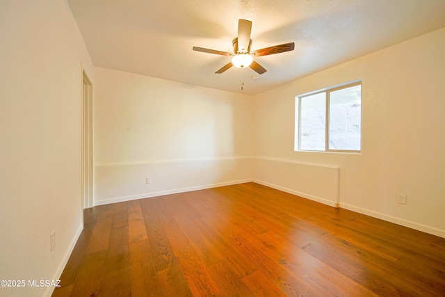 spare room featuring ceiling fan and hardwood / wood-style floors