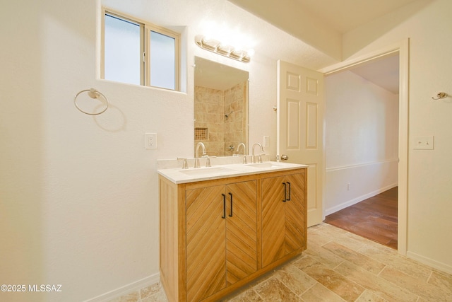 bathroom featuring a shower and vanity