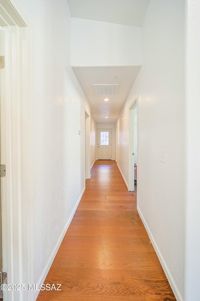 corridor with light wood-type flooring