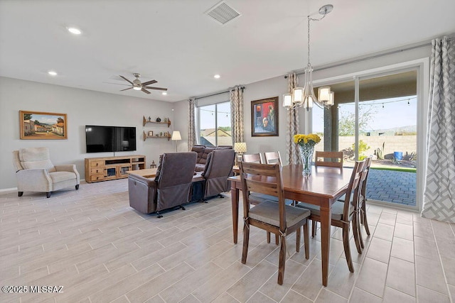 dining area with ceiling fan with notable chandelier