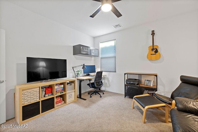 carpeted office space with ceiling fan