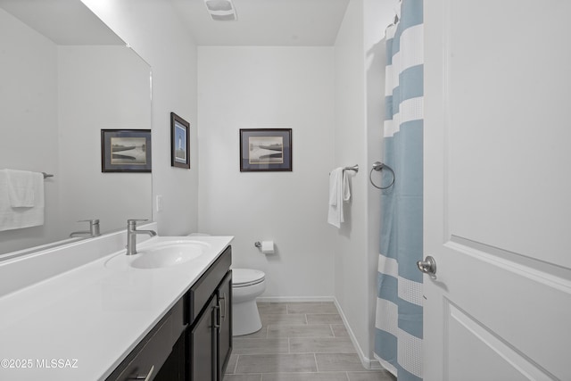 bathroom featuring vanity and toilet