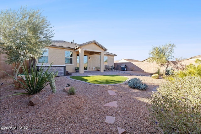 rear view of house with a yard and a patio area