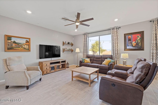 living room with light hardwood / wood-style floors and ceiling fan