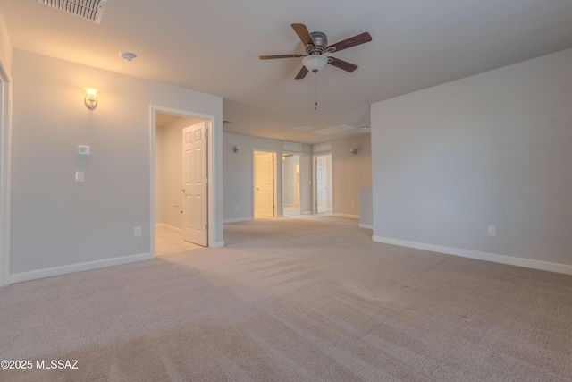 carpeted spare room featuring ceiling fan