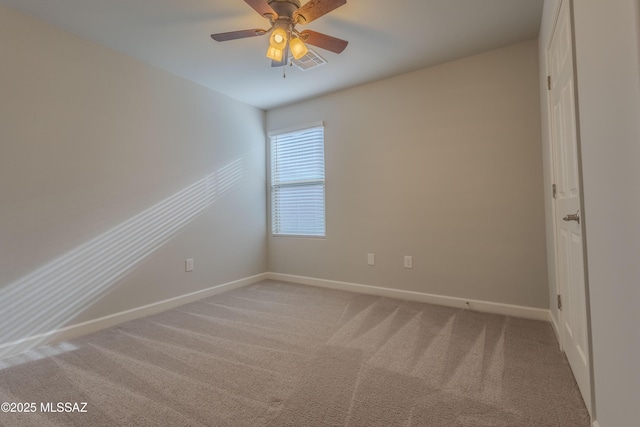 spare room featuring ceiling fan and carpet