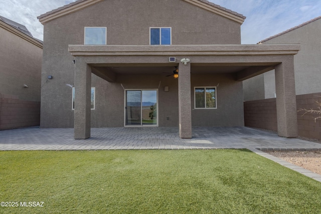 back of house featuring a yard, a patio area, and ceiling fan