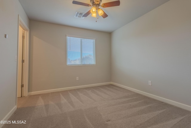 spare room with light colored carpet and ceiling fan