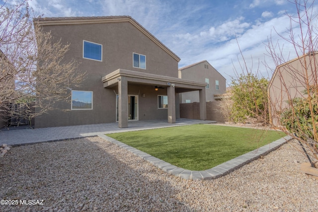 back of property with a patio and a lawn