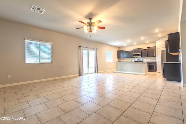 unfurnished living room featuring light tile patterned flooring and ceiling fan