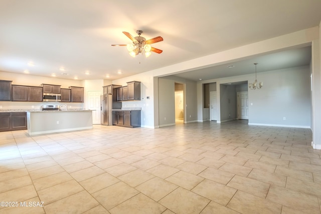 unfurnished living room featuring ceiling fan with notable chandelier and light tile patterned floors