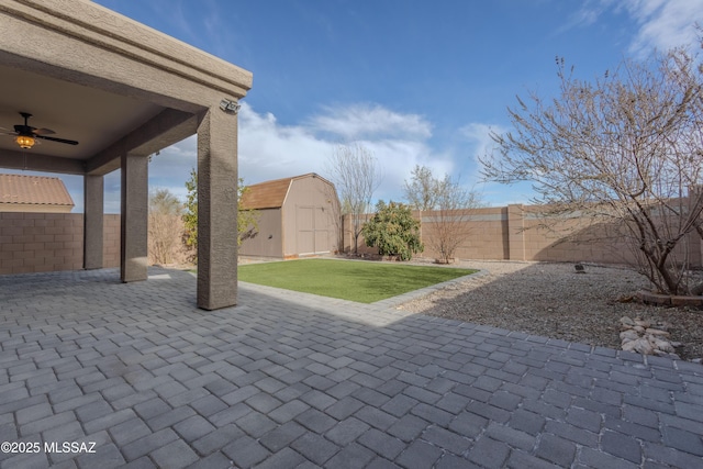 view of patio / terrace featuring ceiling fan and a storage shed