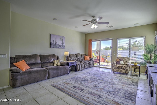 tiled living room with ceiling fan